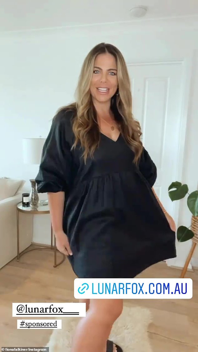 Back in black: She also wore a little black dress in a satin fabric with puffy long sleeves and a babydoll cut